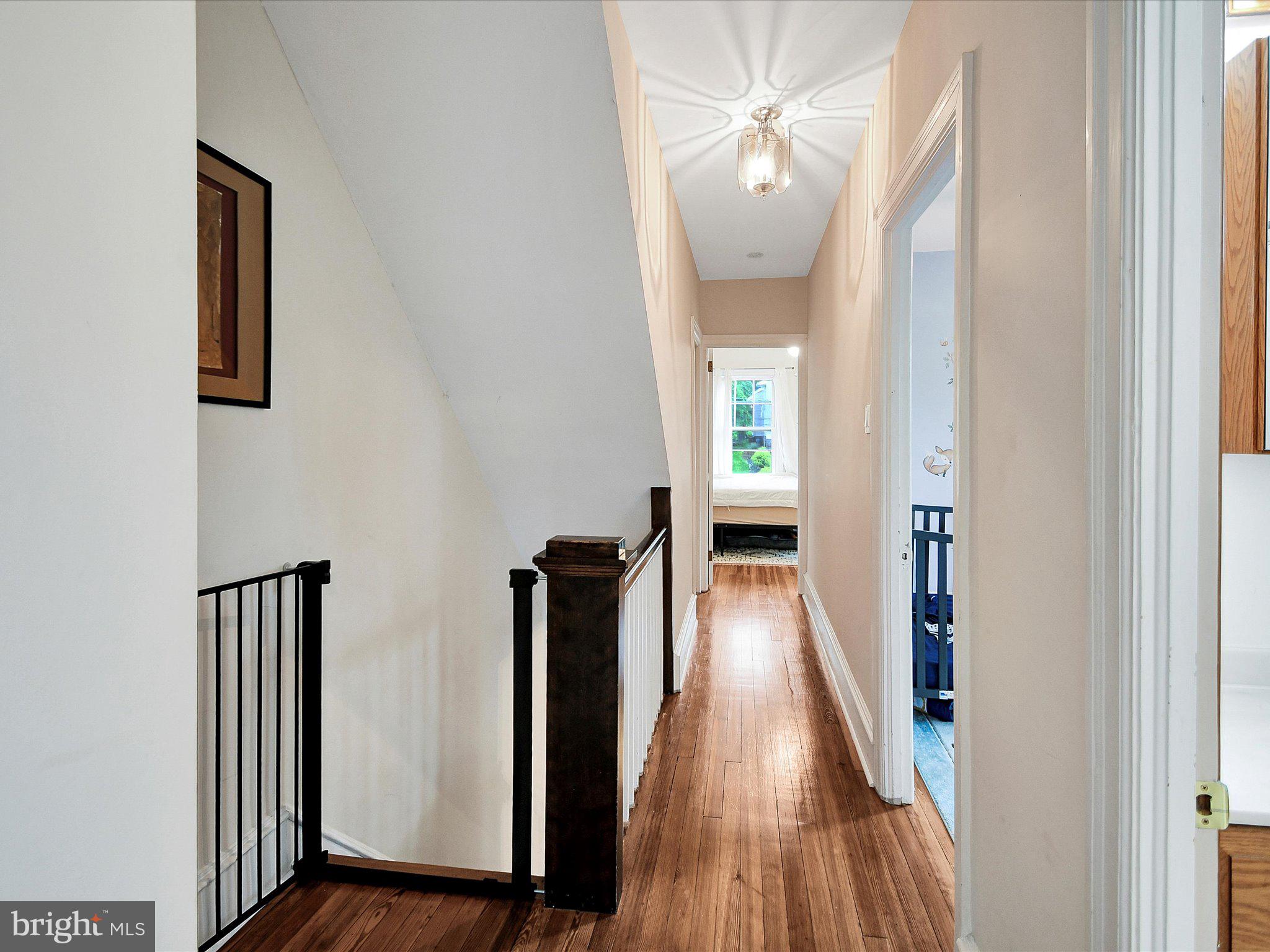 3 Bells Mill Road Glenside, PA 19038 - Photo 15 of 38 a view of a hallway with wooden floor and staircase