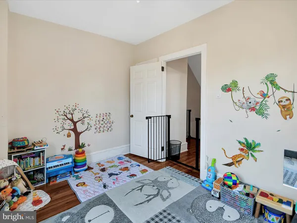 a bedroom with toys and a wooden floor