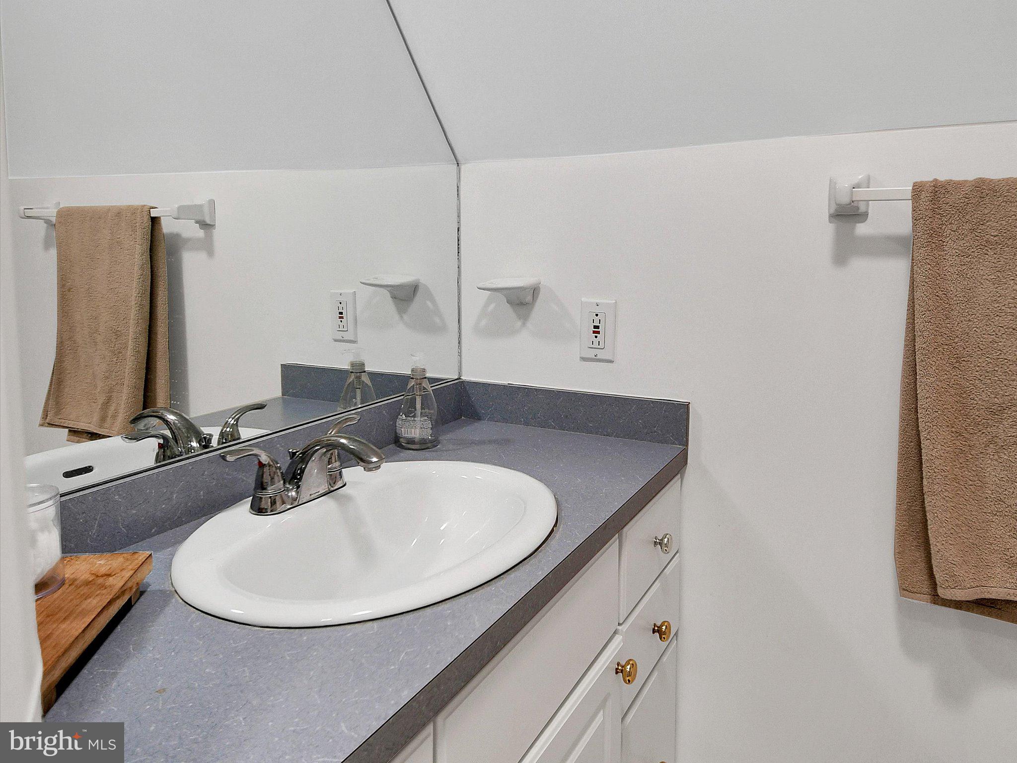 3 Bells Mill Road Glenside, PA 19038 - Photo 26 of 38 a bathroom with a sink and a mirror