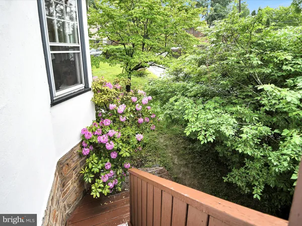 a view of a balcony with flower plants