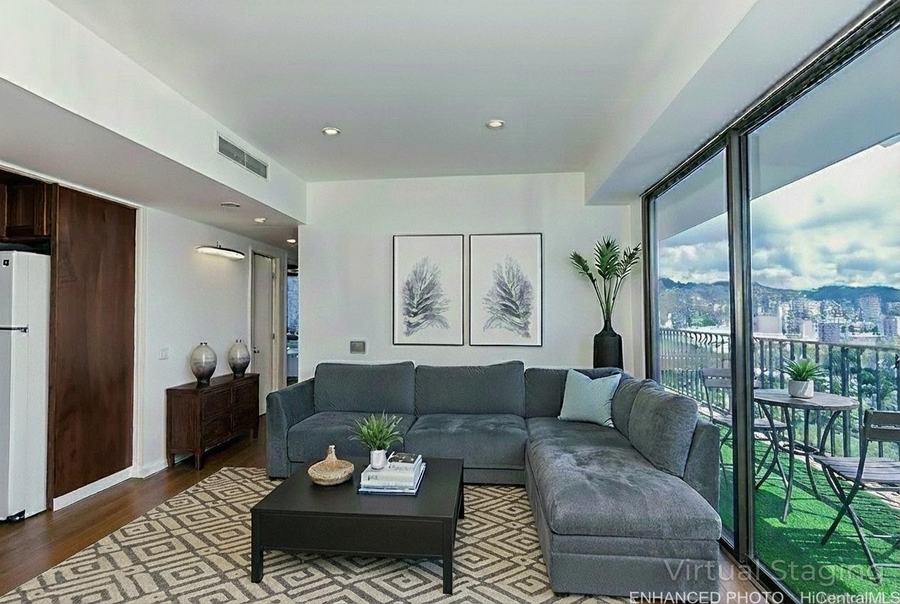 225 Queen Street, Unit 21H Honolulu, HI 96813 - Photo 2 of 25 Enhanced photo Very Comfortable living room with beautiful views of Skyline of Kakaako New Buildings and Ocean