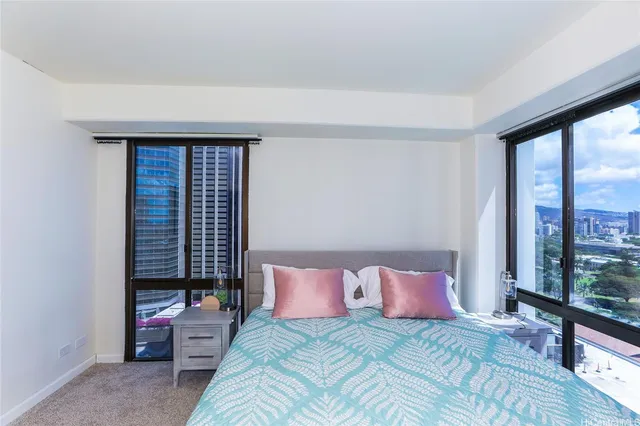 a bedroom with a bed wooden floor and window