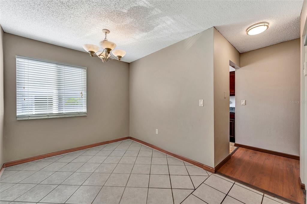 13300 Walsingham Road, Unit 56 Largo, FL 33774 - Photo 8 of 35 a view of an empty room with window and chandelier fan