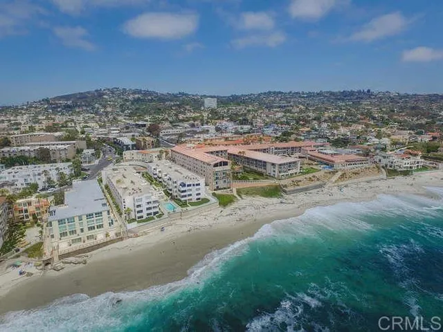 a patio with a table and chairs under an umbrella