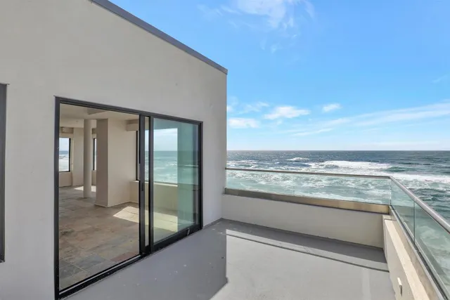 a view of a kitchen with refrigerator and more cabinets