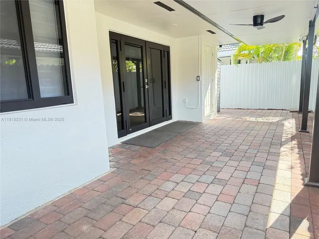 a view of a pathway of a house with wooden walls