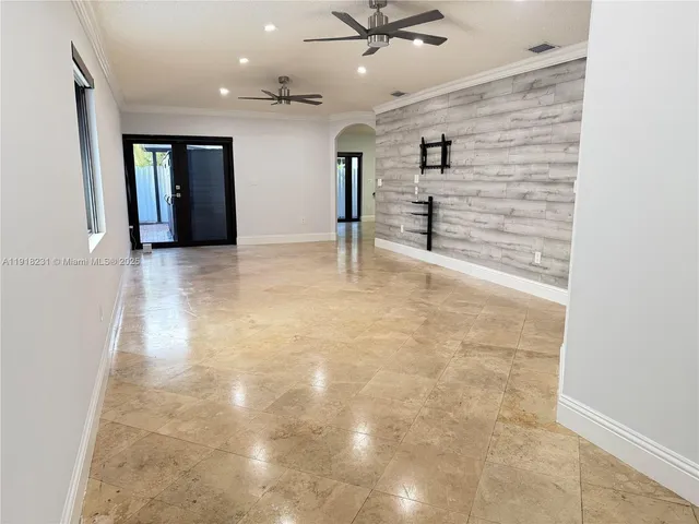 an empty room with windows and cabinet
