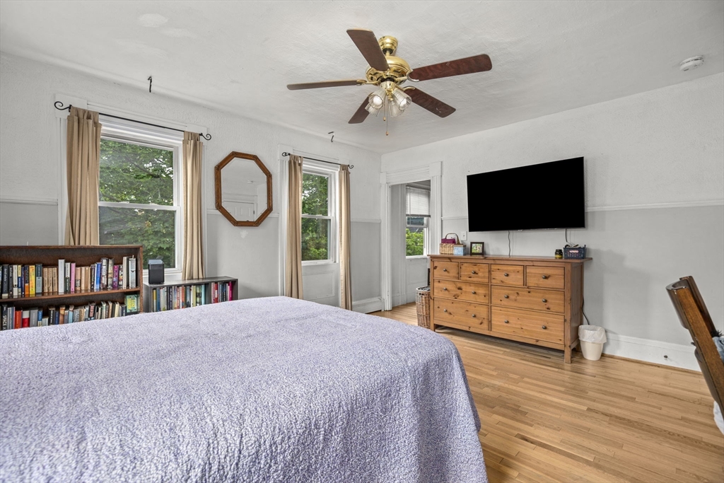 145 High Street, Unit 2 Danvers, MA 01923 - Photo 11 of 40 a bedroom with a bed and a flat screen tv