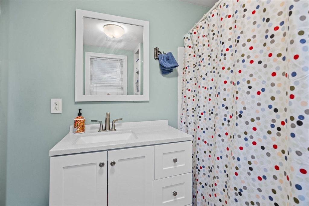 145 High Street, Unit 2 Danvers, MA 01923 - Photo 16 of 40 a bathroom with a sink and a mirror