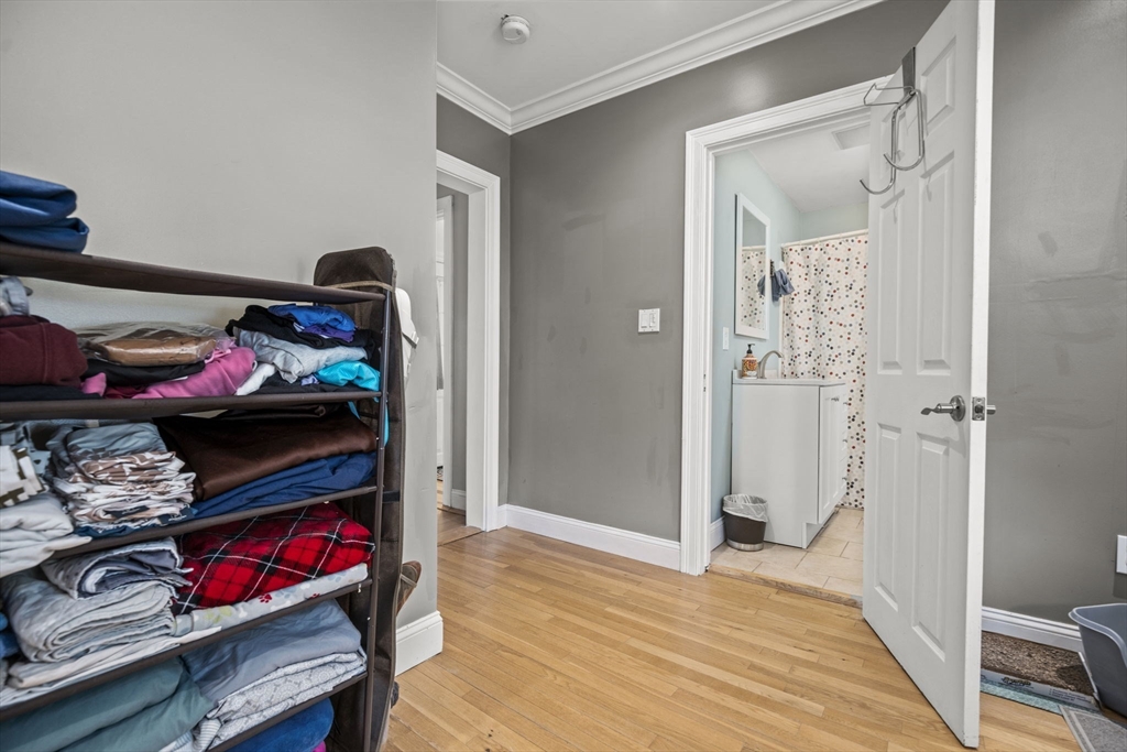 145 High Street, Unit 2 Danvers, MA 01923 - Photo 18 of 40 a bedroom with a bed and a wooden floor