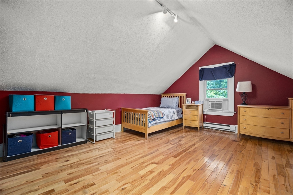 145 High Street, Unit 2 Danvers, MA 01923 - Photo 22 of 40 a living room with furniture and a wooden floor