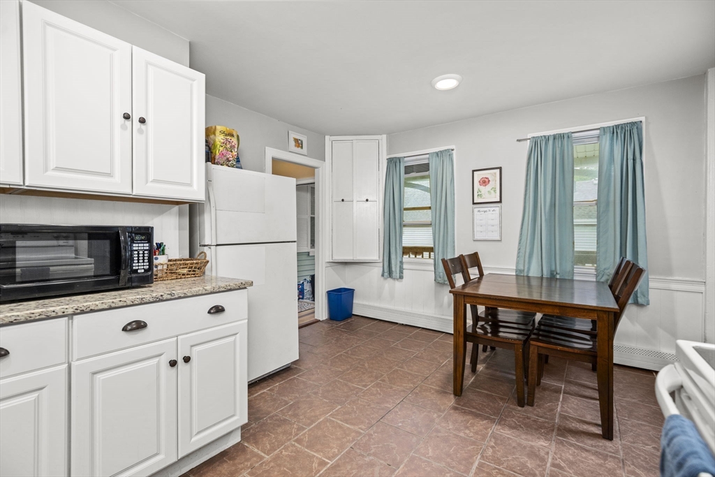 145 High Street, Unit 2 Danvers, MA 01923 - Photo 7 of 40 a kitchen with granite countertop a sink cabinets and stainless steel appliances