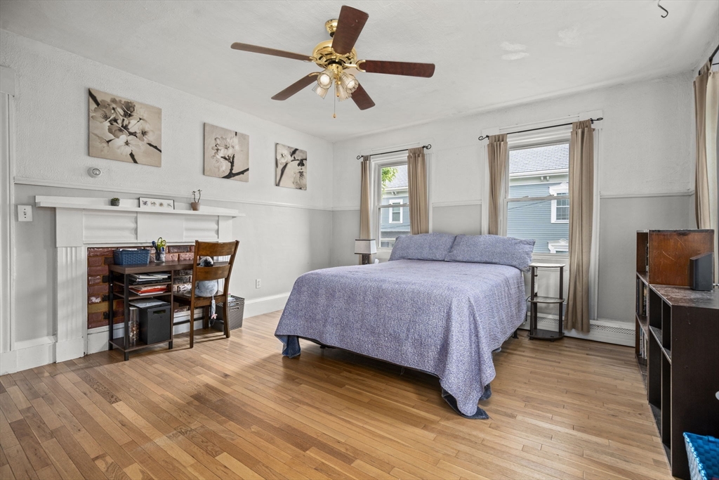 145 High Street, Unit 2 Danvers, MA 01923 - Photo 9 of 40 a bedroom with a bed and a table chair