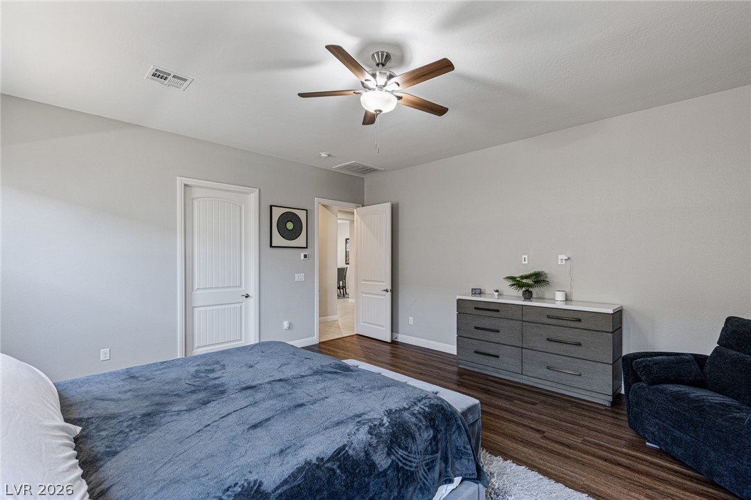 7036 Arabian Ridge Street Las Vegas, NV 89131 - Photo 28 of 64 Rich hardwood floors complement a neutral palette in this spacious bedroom.
