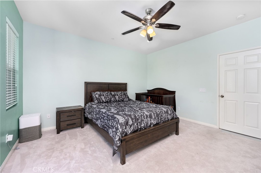 3257 Moss Landing Boulevard Oxnard, CA 93036 - Photo 12 of 29 a bedroom with a bed and a chandelier