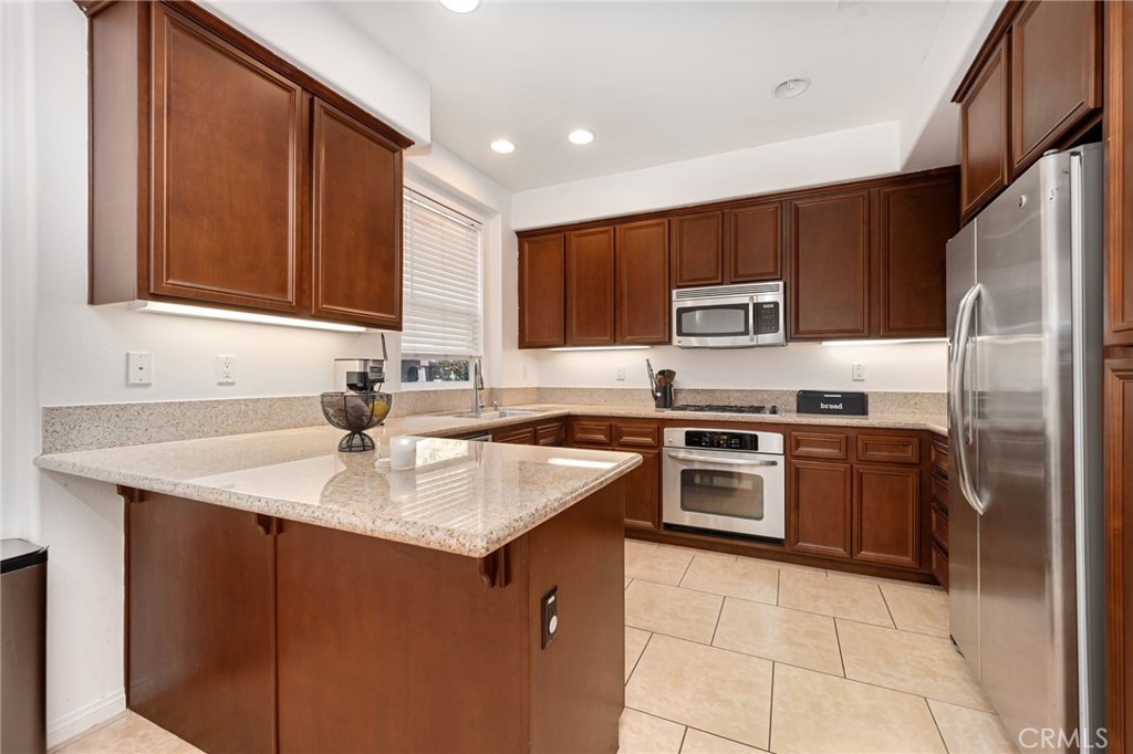 3257 Moss Landing Boulevard Oxnard, CA 93036 - Photo 20 of 29 a kitchen with a sink stove and refrigerator