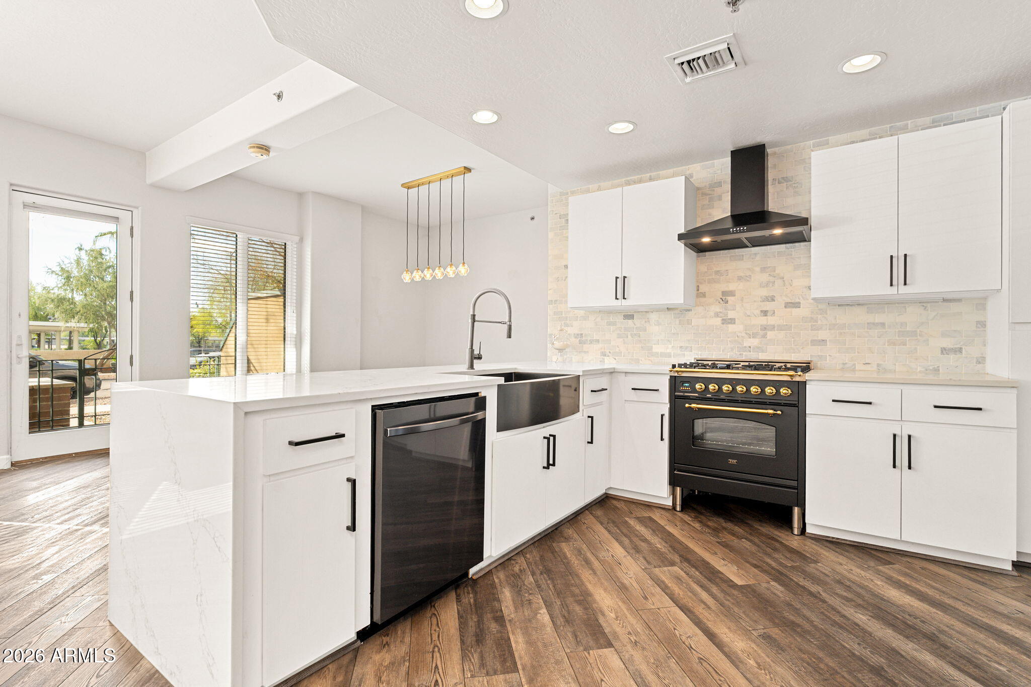 16 West Encanto Boulevard, Unit 12 Phoenix, AZ 85003 - Photo 13 of 42 a kitchen with granite countertop a sink cabinets stainless steel appliances and a window