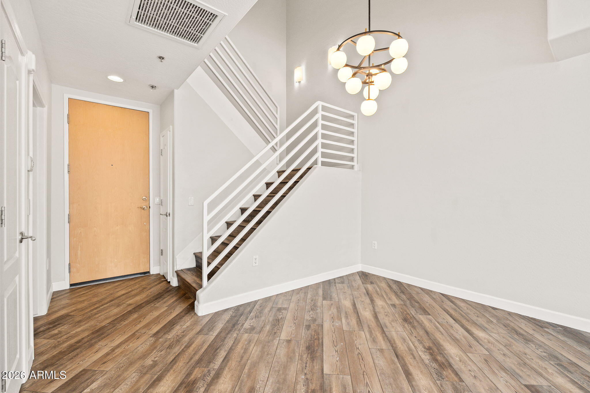 16 West Encanto Boulevard, Unit 12 Phoenix, AZ 85003 - Photo 17 of 42 a view of a room with wooden floor and chandelier