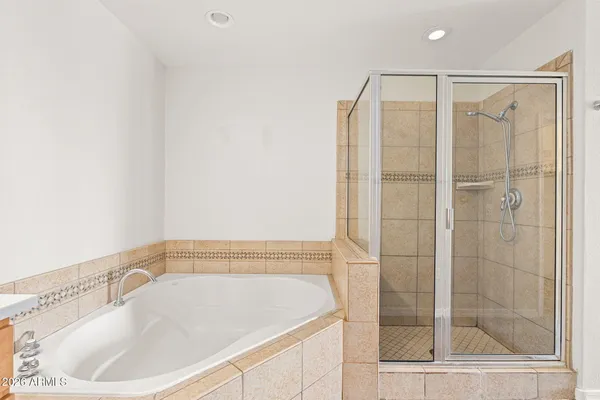 a bathroom with a bathtub and a shower