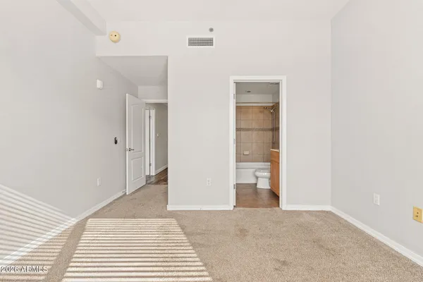 a view of a big room with closet and mirror