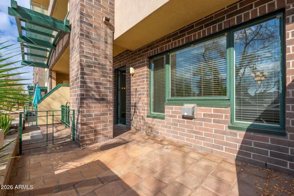 a view of a brick house with a large window