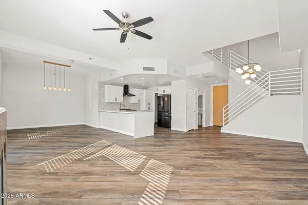 a view of a kitchen with wooden floor and a ceiling fan