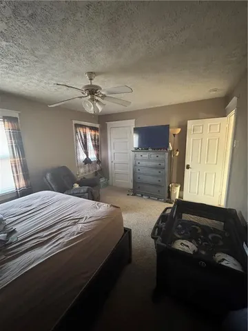 a spacious bedroom with a bed and a window