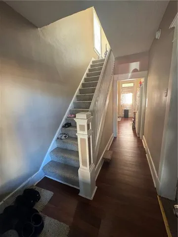 a view of entryway and hall with wooden floor