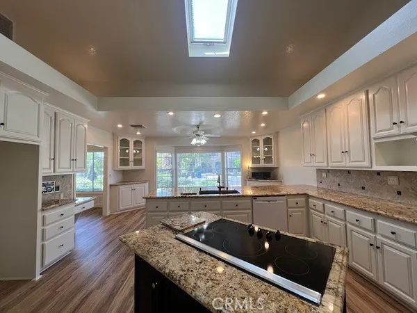 a kitchen with granite countertop lots of counter top space and center island