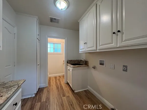 a kitchen with granite countertop stainless steel appliances a stove window and cabinets