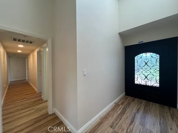 a view of hallway with wooden floor and staircase