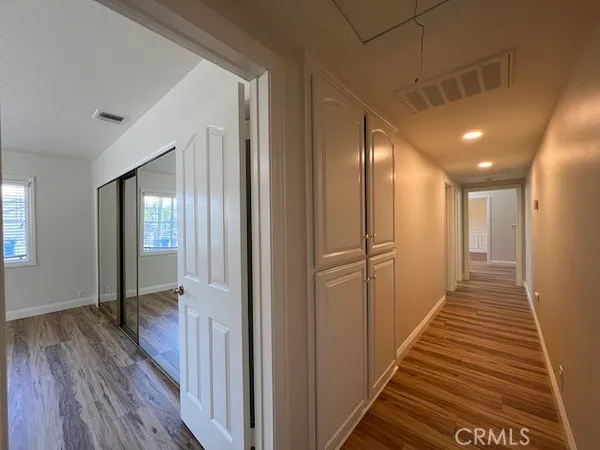 a view of a hallway with wooden floor
