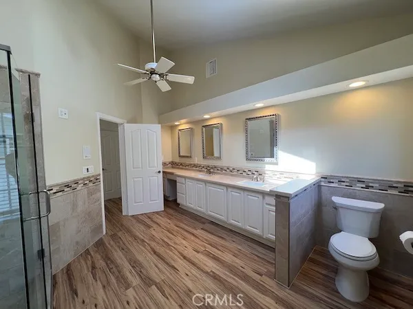 a spacious bathroom with a granite countertop sink mirror and a bathtub