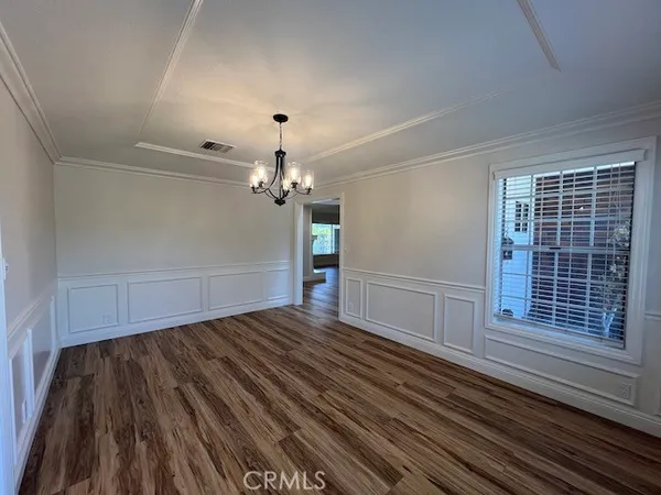 a view of a room with wooden floor