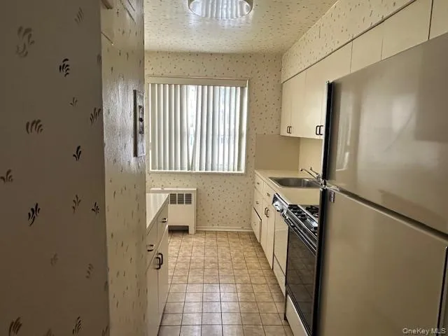 a kitchen with a refrigerator and a stove
