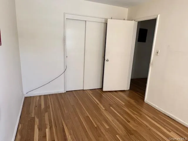 a view of a room with wooden floor and white walls