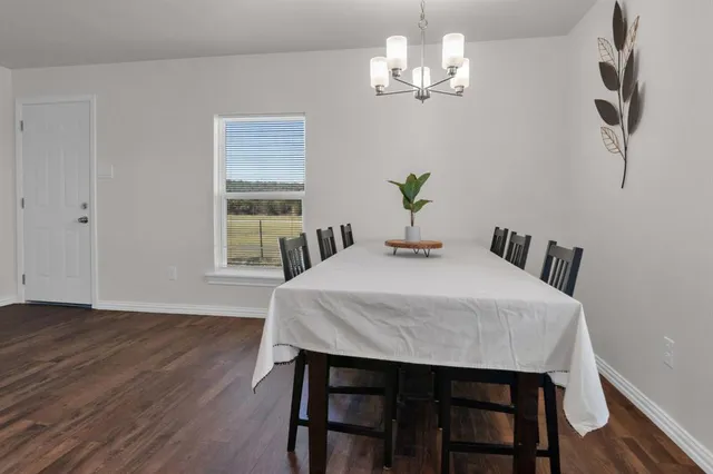 a view of a dining room with furniture wooden floor and chandelier