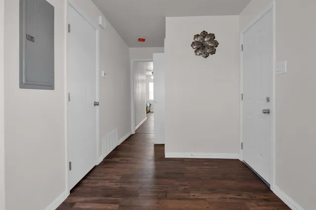 a view of a hallway with wooden floor