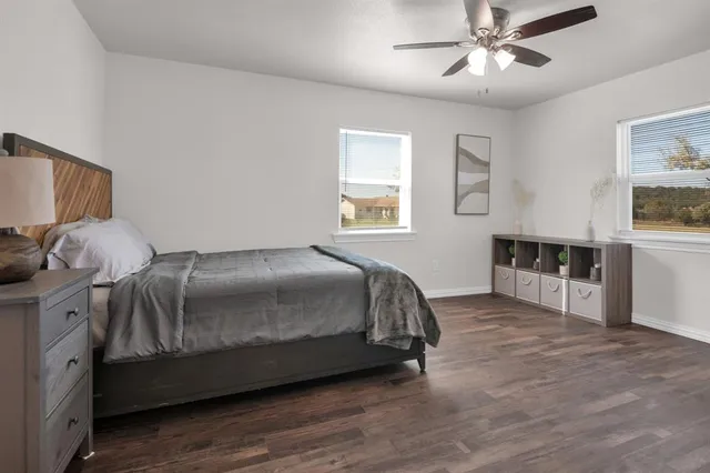 a spacious bedroom with a bed and a chandelier