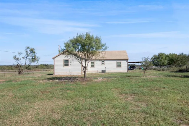 a view of a yard with a tree
