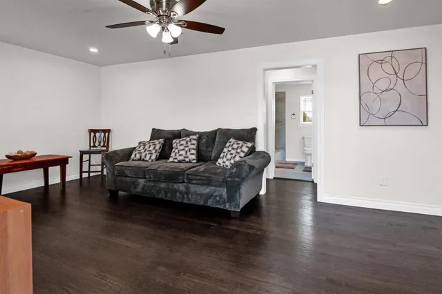 a living room with furniture and a wooden floor