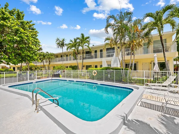 a swimming pool with outdoor seating and yard