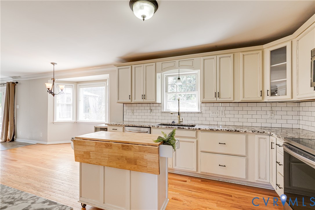 4318 Rose Glen Place Midlothian, VA 23015 - Photo 14 of 33 a kitchen with stainless steel appliances granite countertop a sink a stove cabinets and wooden floor