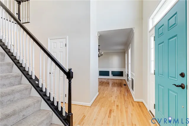a view of a hallway with wooden floor and staircase