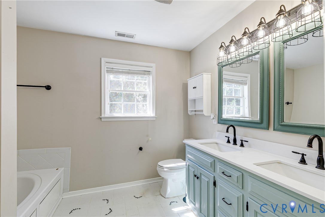 4318 Rose Glen Place Midlothian, VA 23015 - Photo 30 of 33 a bathroom with a double vanity sink a toilet and a bathtub