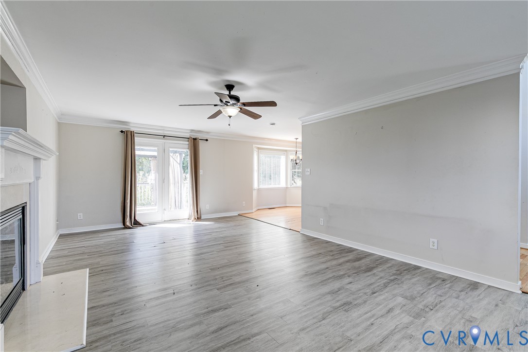 4318 Rose Glen Place Midlothian, VA 23015 - Photo 7 of 33 a view of an empty room with a fireplace and wooden floor