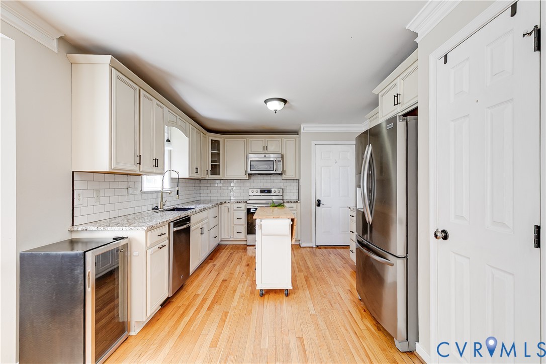4318 Rose Glen Place Midlothian, VA 23015 - Photo 10 of 33 a kitchen with stainless steel appliances granite countertop a refrigerator a stove a sink and white cabinets with wooden floor