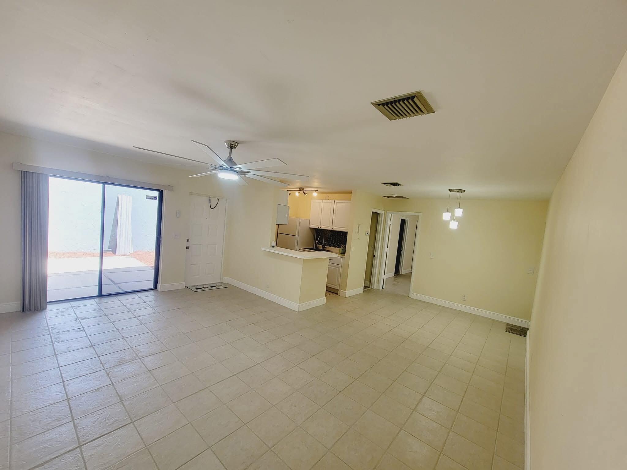 2 Crossings Circle, Unit B Boynton Beach, FL 33435 - Photo 4 of 12 an empty room with a kitchen and a sink