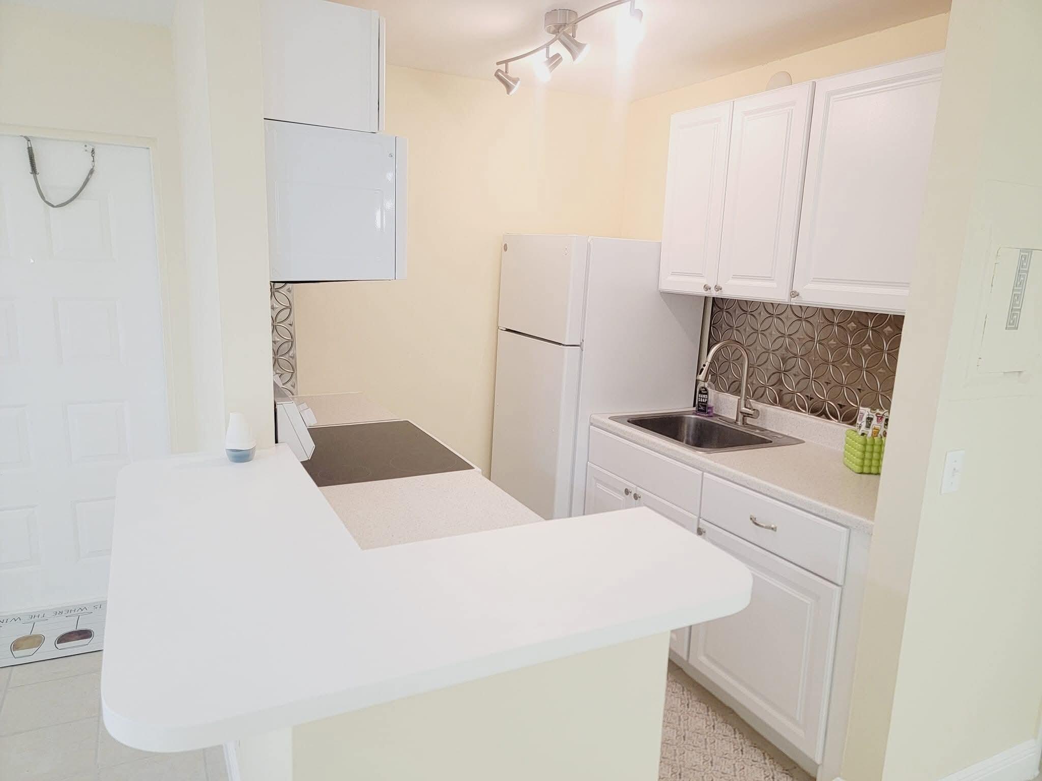 2 Crossings Circle, Unit B Boynton Beach, FL 33435 - Photo 5 of 12 a bedroom with a bed and a cabinets