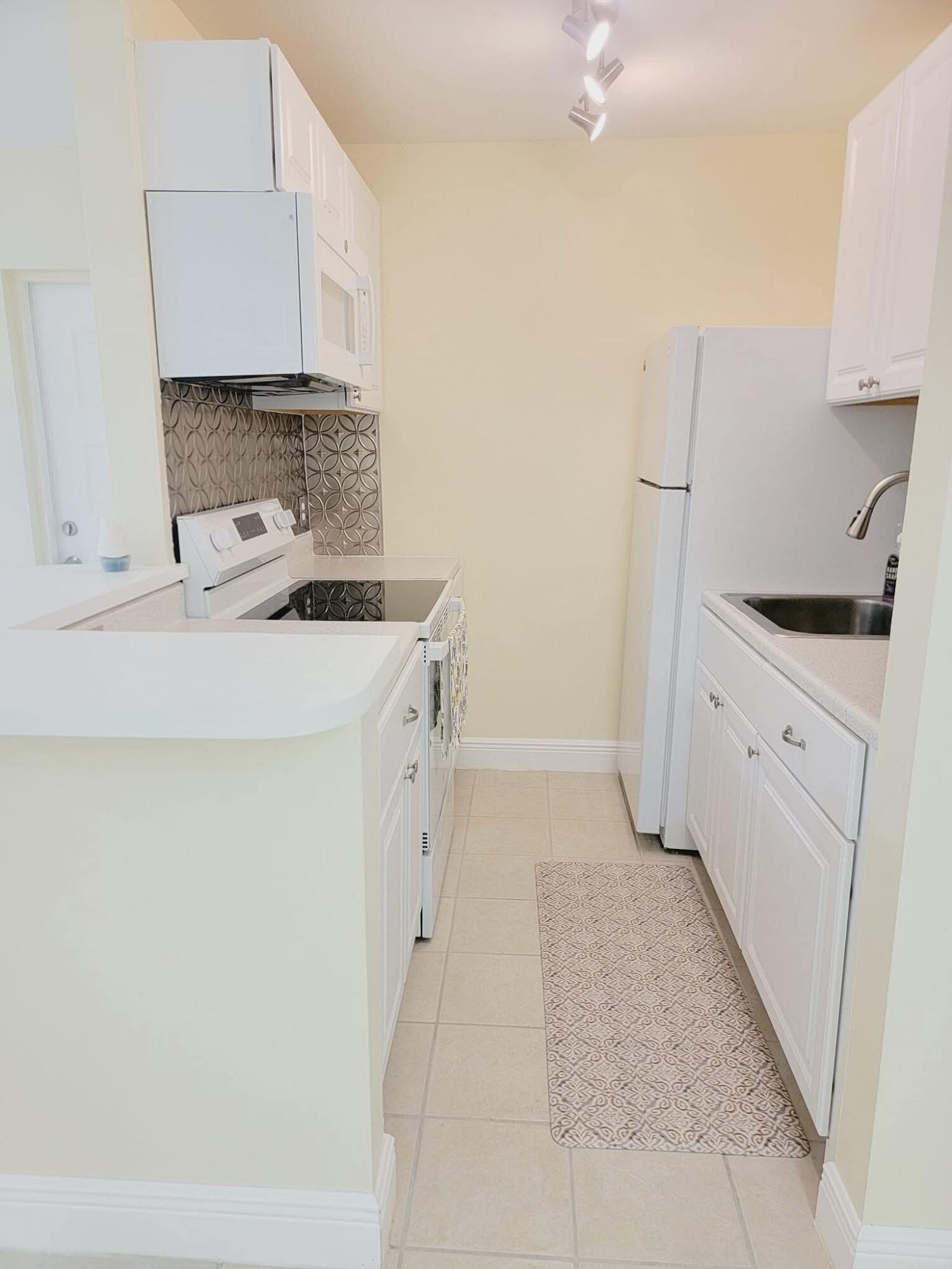 2 Crossings Circle, Unit B Boynton Beach, FL 33435 - Photo 6 of 12 a kitchen with cabinets and appliances